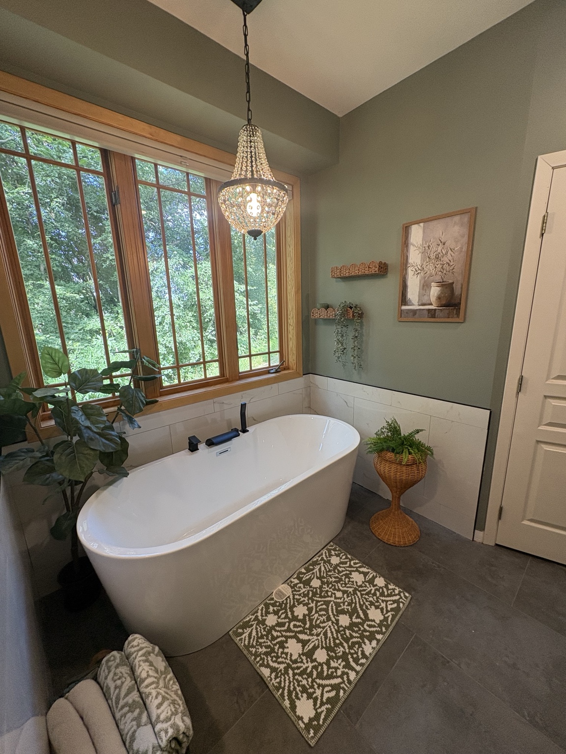 Finished bathroom with freestanding tub and tile flooring