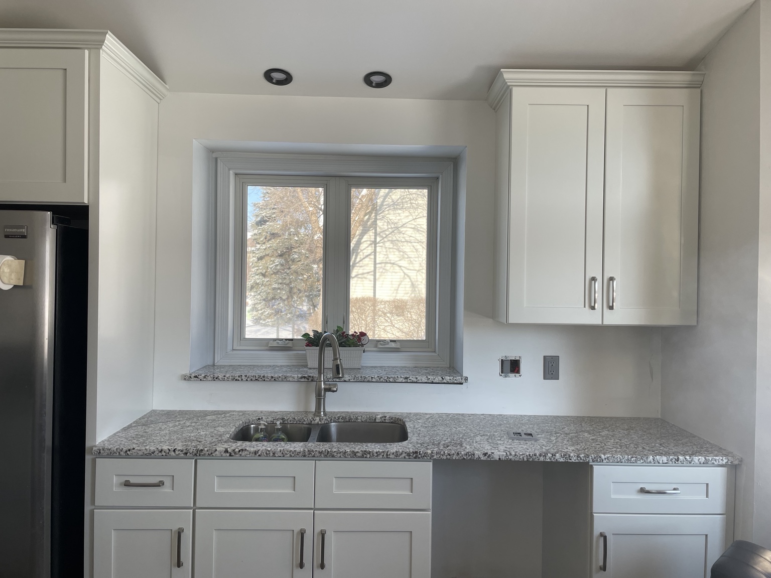 Bright renovated kitchen with white cabinets