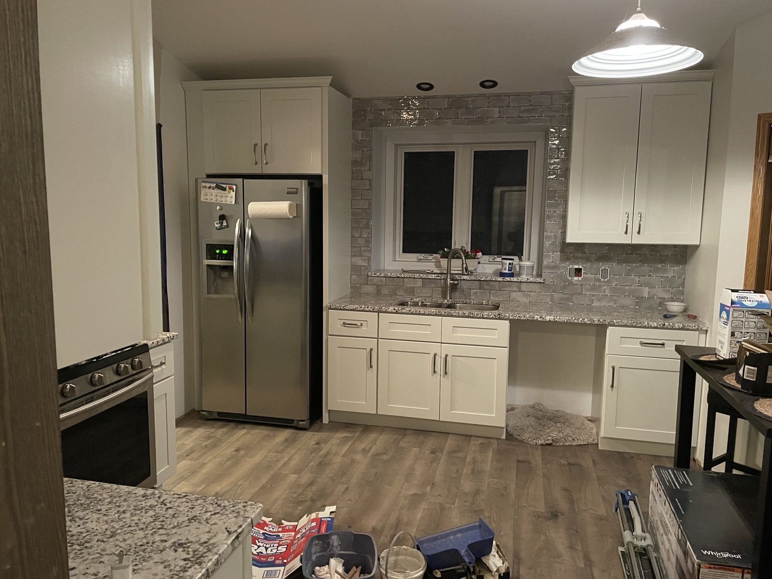 Renovated kitchen with white cabinets and stone counters